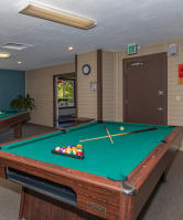 a games room with two pool tables and a foosball table