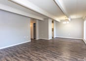 Thumbnail 26 of 27 - A room with wooden flooring and white walls.
