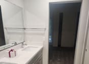 Thumbnail 24 of 82 - A bathroom with a white sink and a mirror.