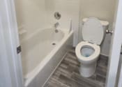Thumbnail 27 of 82 - A white toilet is in a bathroom with a white tub and a shower.