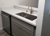 Thumbnail 81 of 82 - A kitchen with a white countertop and a stainless steel sink.