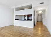 Thumbnail 66 of 74 - A white kitchen with wooden floors and a white ceiling.