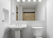 Thumbnail 72 of 74 - A white sink and toilet in a small bathroom.