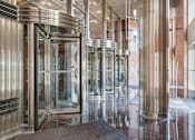 Thumbnail 4 of 74 - A set of shiny metal turnstiles in a building.