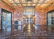 Thumbnail 5 of 74 - A hallway with marble floors and walls, with a date stamp of 1878-1935.
