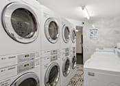 Thumbnail 34 of 74 - A row of LG washing machines in a laundromat.