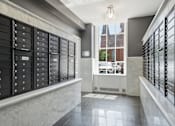 Thumbnail 36 of 74 - A row of black mailboxes on a marble ledge.