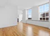 Thumbnail 57 of 74 - A room with wooden floors and white walls.