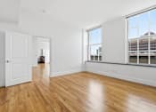 Thumbnail 56 of 74 - A room with wooden floors and white walls.