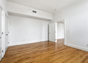 Thumbnail 58 of 74 - A room with wooden floors and white walls.