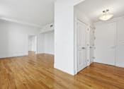 Thumbnail 63 of 74 - A room with wooden floors and white walls.