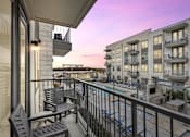 Thumbnail 3 of 39 - a balcony over looking a pool area at LynnCora at LynnCora, Grand Prairie, Texas