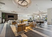 Thumbnail 15 of 39 - 9,000 square-foot resident lounge and clubhouse with fireplace at LynnCora, Grand Prairie, TX, 75052