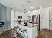 Thumbnail 19 of 39 - the residence on lamar apartment kitchens with granite counter tops and stainless steel appliances at LynnCora, Grand Prairie