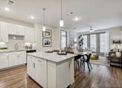 Thumbnail 28 of 39 - a kitchen and dining room with white cabinets and a white counter top at LynnCora, Texas, 75052