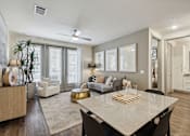 Thumbnail 32 of 39 - an open living room and dining room with a white table at LynnCora, Grand Prairie, TX, 75052