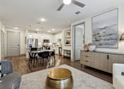 Thumbnail 33 of 39 - a living room and kitchen with a dining room table and chairs at LynnCora, Grand Prairie, TX