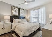 Thumbnail 34 of 39 - a bedroom with a bed and a ceiling fan at LynnCora, Grand Prairie, 75052