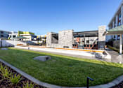 Thumbnail 14 of 18 - A modern building with a Bocce Court in front