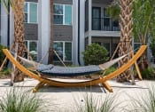Thumbnail 11 of 79 - a hammock in resident courtyard lounge area at Mira at Palmer Ranch in Sarasota, FL