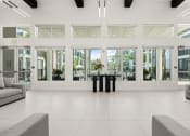 Thumbnail 20 of 79 - clubhouse view to pool area with wall of windows at Mira at Palmer Ranch in Sarasota, FL