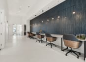 Thumbnail 37 of 79 - a reception area with chairs and a long table at Mira at Palmer Ranch in Sarasota, FL