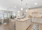 Thumbnail 46 of 79 - a kitchen and living room with Italian cabinets and a granite counter top at Mira at Palmer Ranch, Florida, 34238
