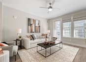 Thumbnail 49 of 79 - spacious living room with a couch and a coffee table and ceiling fan at Mira at Palmer Ranch, Sarasota
