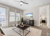 Thumbnail 50 of 79 - an open living room with a ceiling fan and a table at Mira at Palmer Ranch, Sarasota, FL, Florida