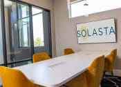 Thumbnail 21 of 25 - apartments conference room with a white table at Solasta, Sacramento, CA, 95831