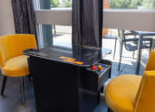 Thumbnail 14 of 25 - a game table in a room with yellow chairs at Solasta, Sacramento, CA, 95831