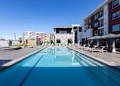 Thumbnail 6 of 18 - A large swimming pool with Amara Apartment buildings in the background
