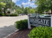 Thumbnail 1 of 10 - A sign that reads Highgate Townhomes in front of a parking lot.