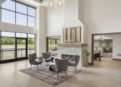 Thumbnail 13 of 29 - a living room with a fireplace and a dining room in the background