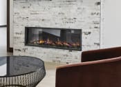 Thumbnail 18 of 29 - a living room with a fireplace and a round table