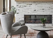 Thumbnail 29 of 29 - a living room with a fireplace and two chairs