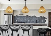 Thumbnail 21 of 29 - a kitchen with white walls and a large island with four black and white bar stools