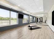 Thumbnail 25 of 29 - a spacious yoga studio with large windows and a large screen tv
