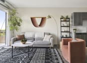 Thumbnail 6 of 29 - a living room with a white couch and a black and white rug