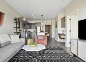 Thumbnail 2 of 29 - a living room with a gray couch and a black and white rug