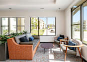 Thumbnail 19 of 35 - A living room with a large window overlooking a street.