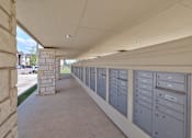 Thumbnail 23 of 35 - A long row of mailboxes are lined up on the side of a building.