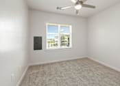Thumbnail 28 of 35 - A room with a ceiling fan and a window with blinds.