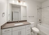 Thumbnail 3 of 35 - A bathroom with a sink, toilet, and bathtub.