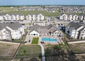 Thumbnail 32 of 35 - A bird's eye view of a residential area with houses and a swimming pool.