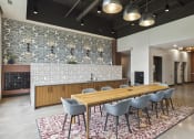 Thumbnail 18 of 26 - a large dining room with a long wooden table and chairs