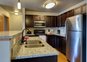 Thumbnail 3 of 80 - Apartment Kitchen at Bluffs of Williston Apartments ND