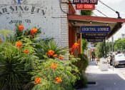Thumbnail 2 of 12 - an old brick building with signs on the side of it