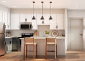 Thumbnail 1 of 12 - a living room and kitchen with white cabinets and a wood floor