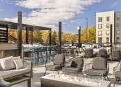 Thumbnail 12 of 33 - outdoor fireplace and lounge area at savor apartments
